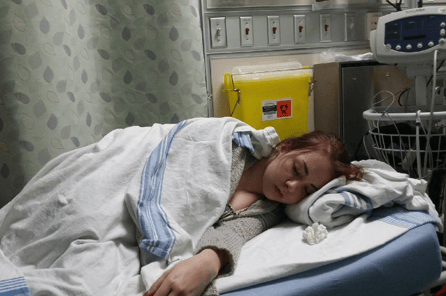 Girl laying in hospital bed