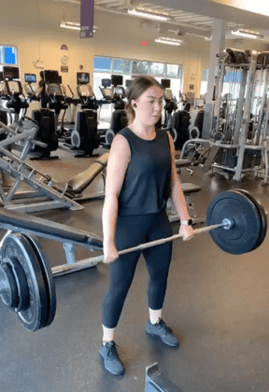 Girl lifting weights at the gym