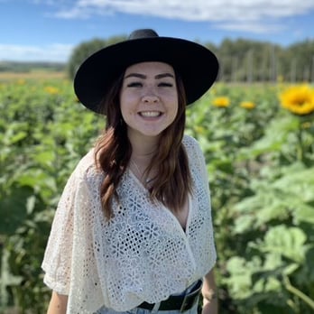 Women smiling in sunflower field 