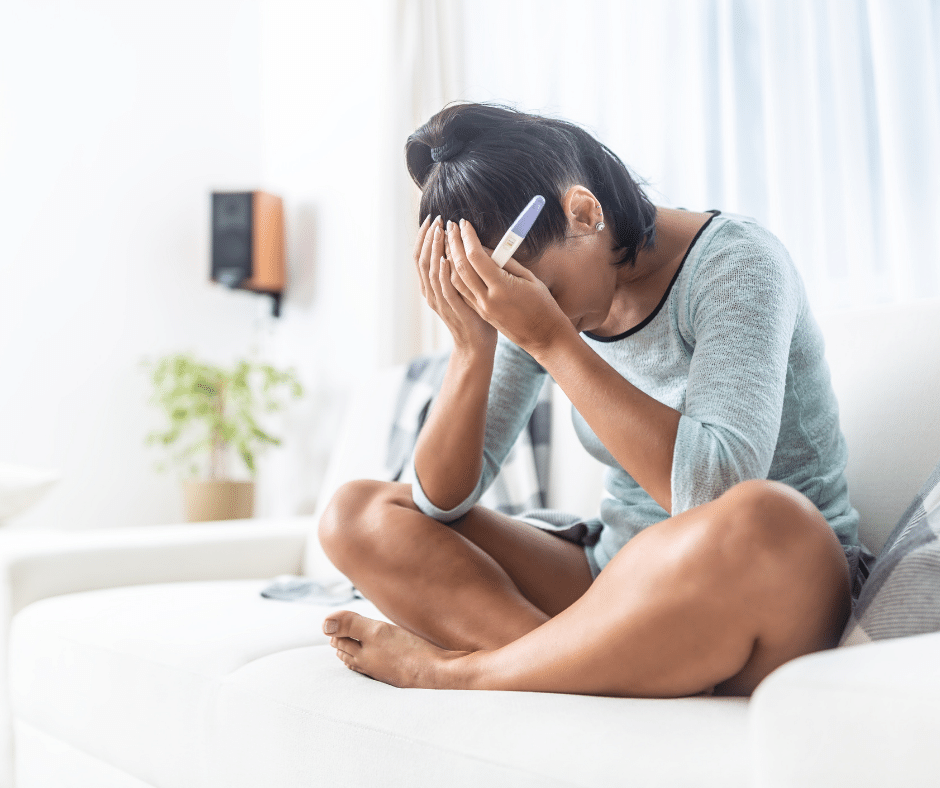 Sad woman with a negative pregnancy test