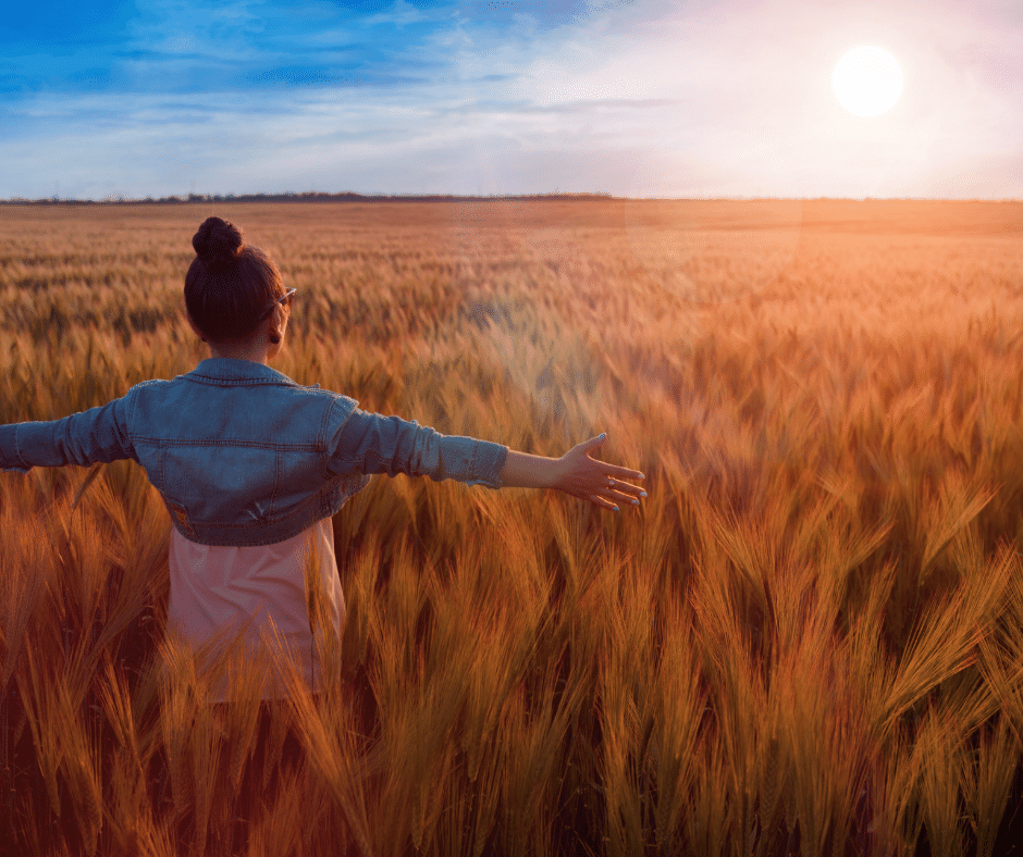 Woman with open arms staring at the sky