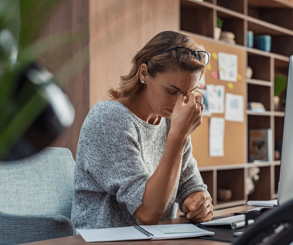 Tired woman sitting at desk