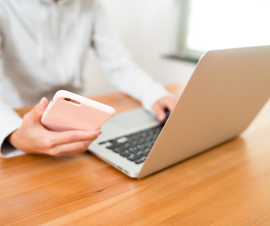 Woman on her digital devices and reading notes