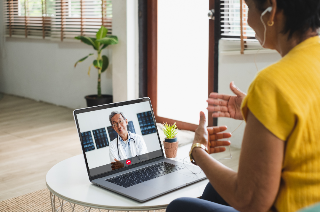 person talking to doctor on computer